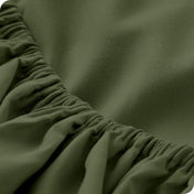 A close-up of a fitted sheet showcasing its elastic edge