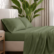 Ultra-soft sheets and pillowcases on a bed with a plant in the background