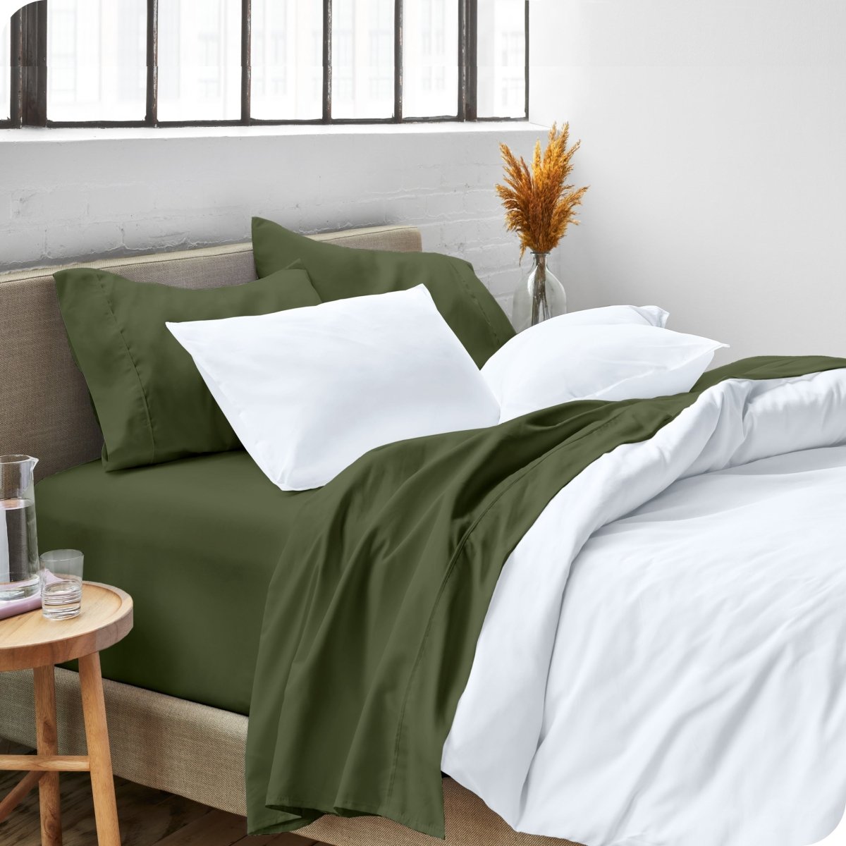 A side view of a bed made with microfiber sheets and a white duvet cover