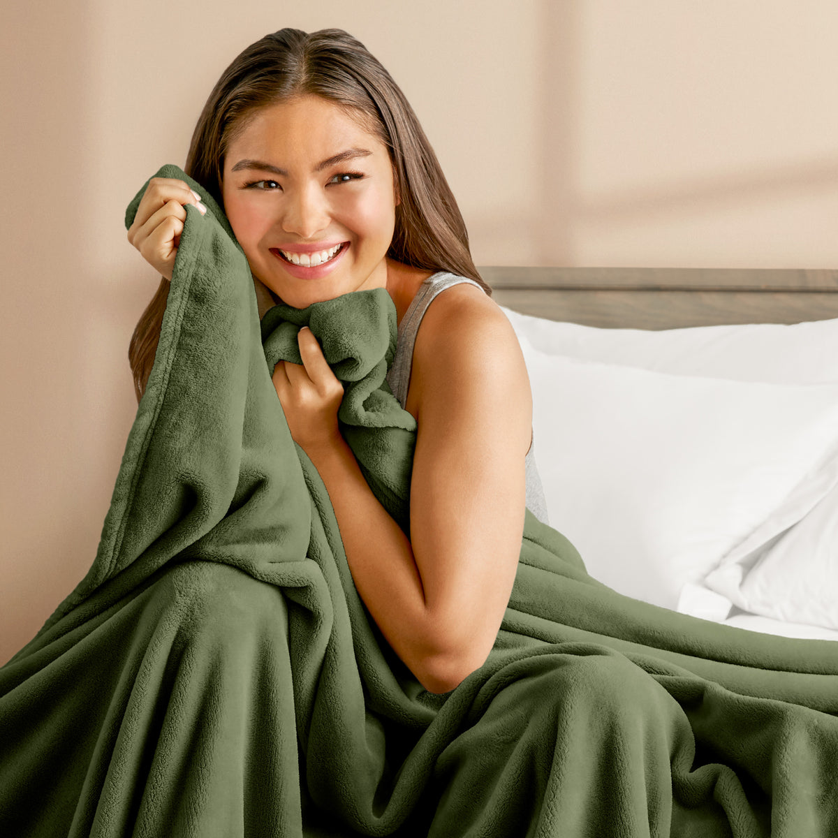 A woman cuddling with a microplush blanket