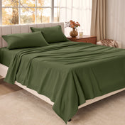Bed sheets on a neatly made bed in a bright bedroom with large windows.