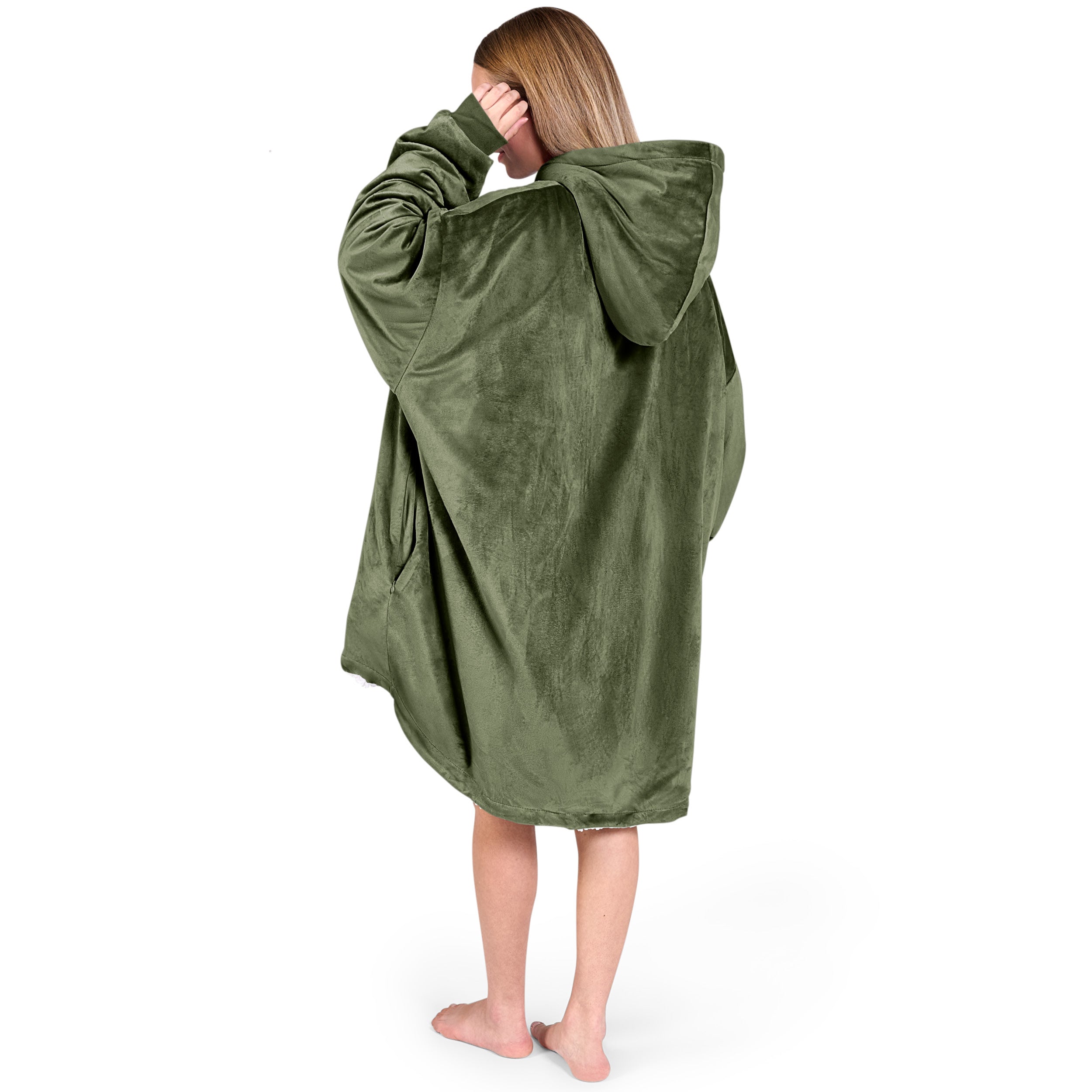 An adult with a hooded wearable blanket on