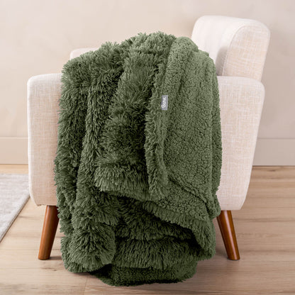 A shaggy blanket draped over the arm of a chair