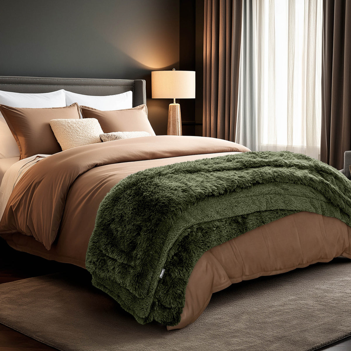A shaggy faux fur blanket at the end of a bed