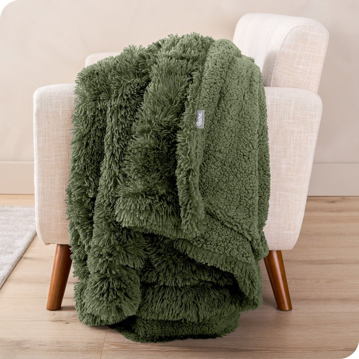 A shaggy faux fur blanket draped over the arm of a chair