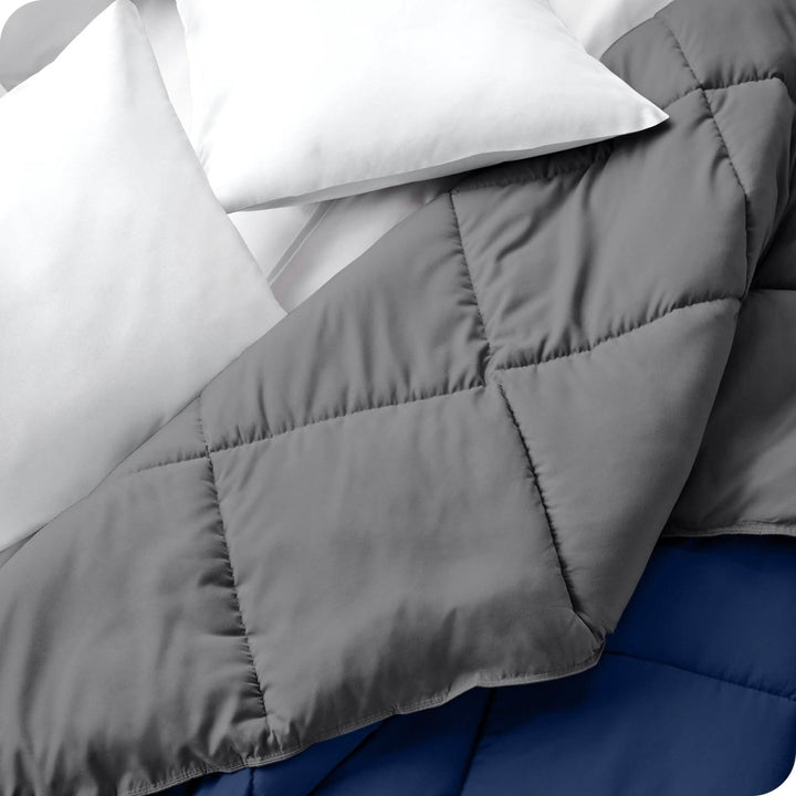 Close up of a comforter folded back to show the different colored sides