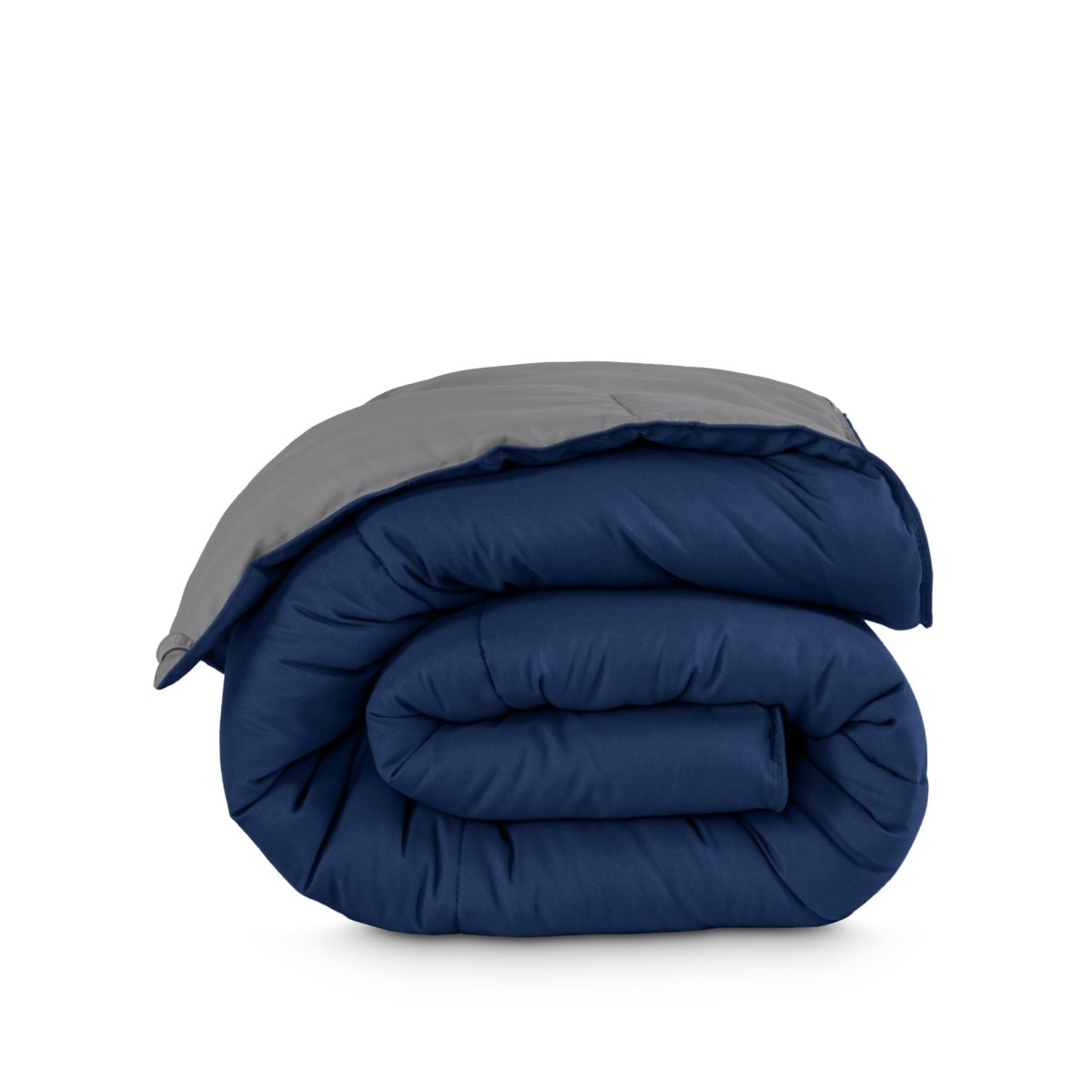 Folded reversible comforter on a white background