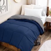 College dorm room with a reversible comforter on the bed