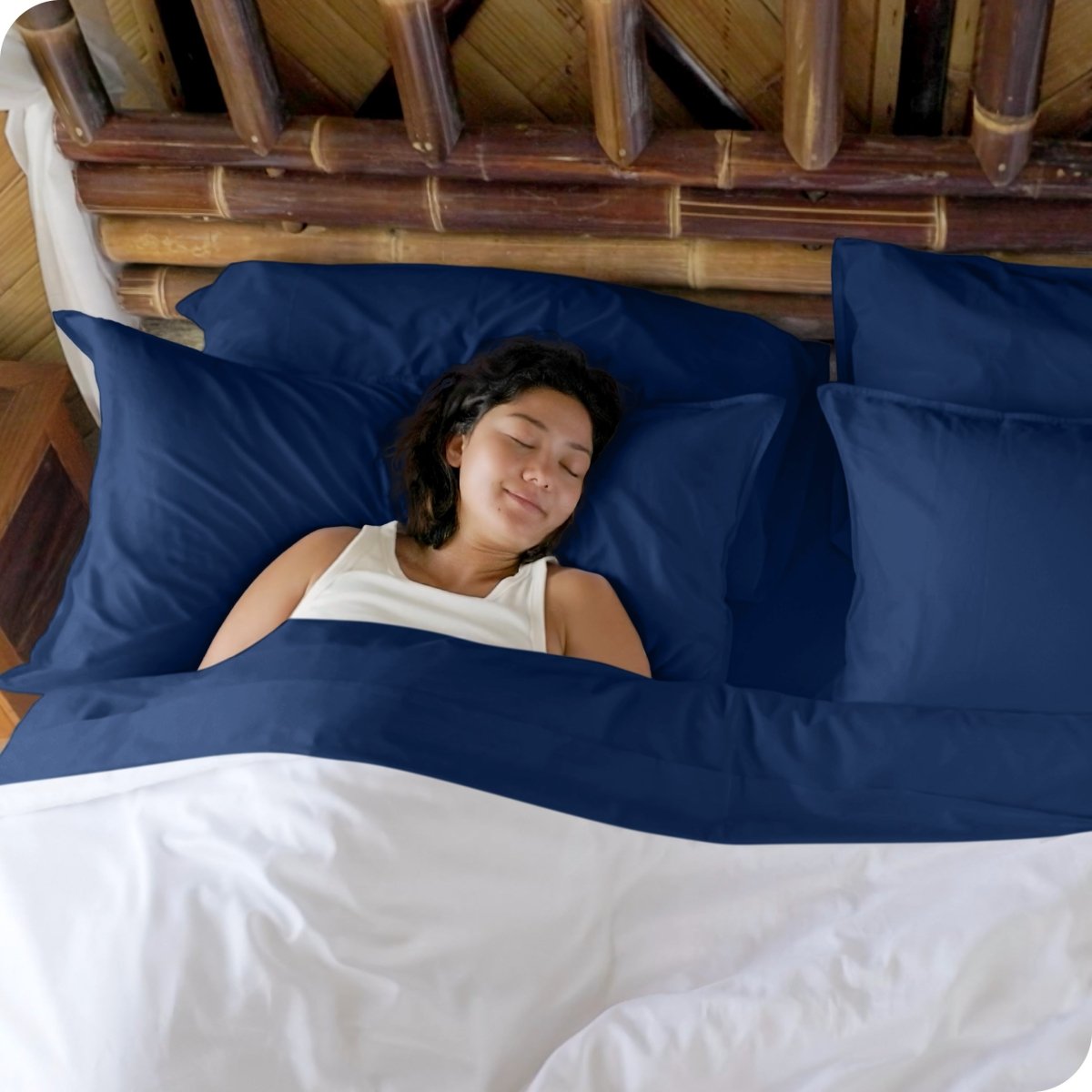 A woman sleeping in a bed made with bamboo sheets