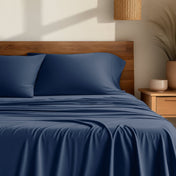 Bamboo sheets on a bed with a wooden headboard