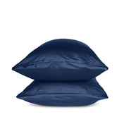 Two blue pillows stacked on a white background