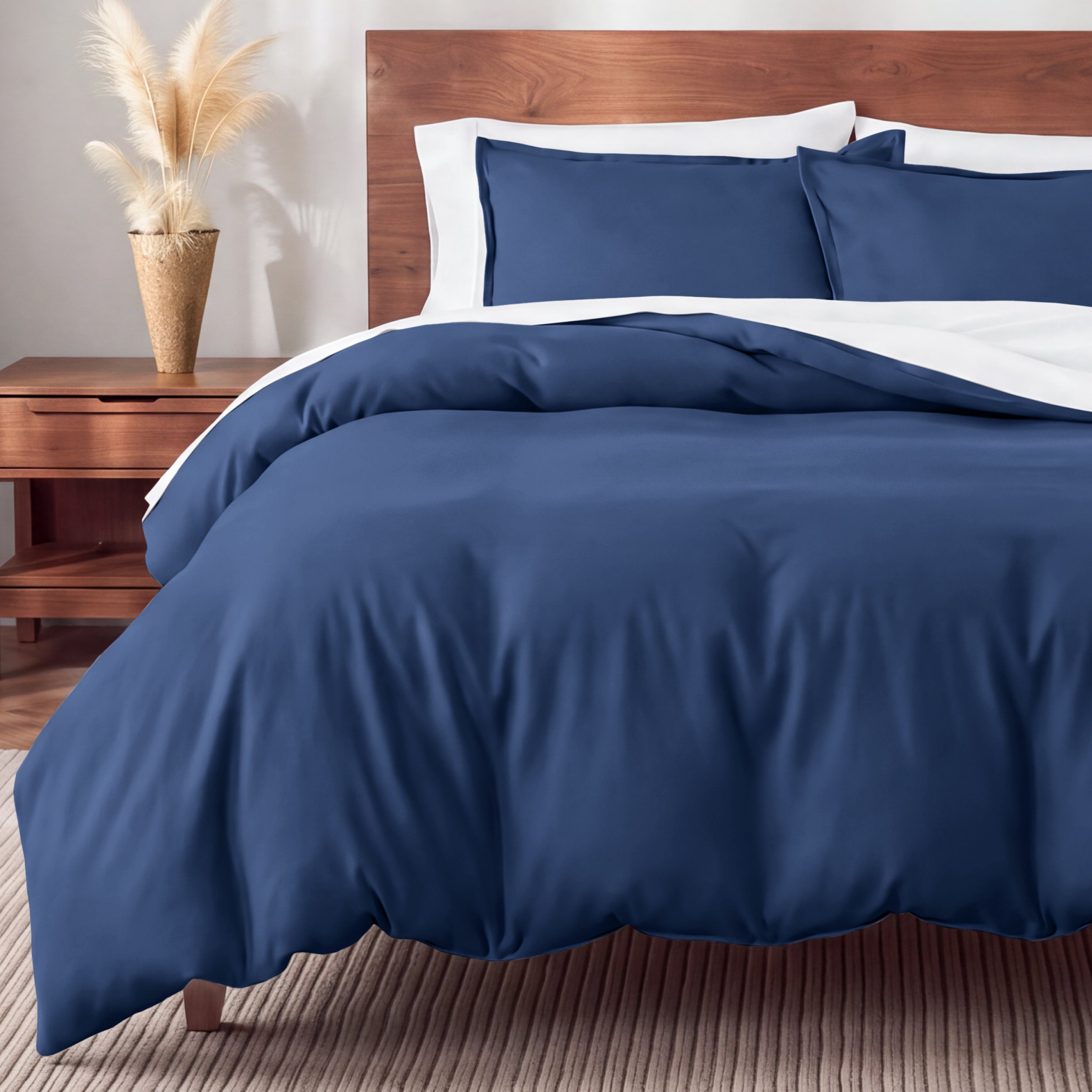 Flannel bedding set on a bed in a bedroom with a nightstand and lamp.