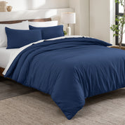 Flannel duvet cover set on a bed in a bedroom with a lamp and plant in the background.