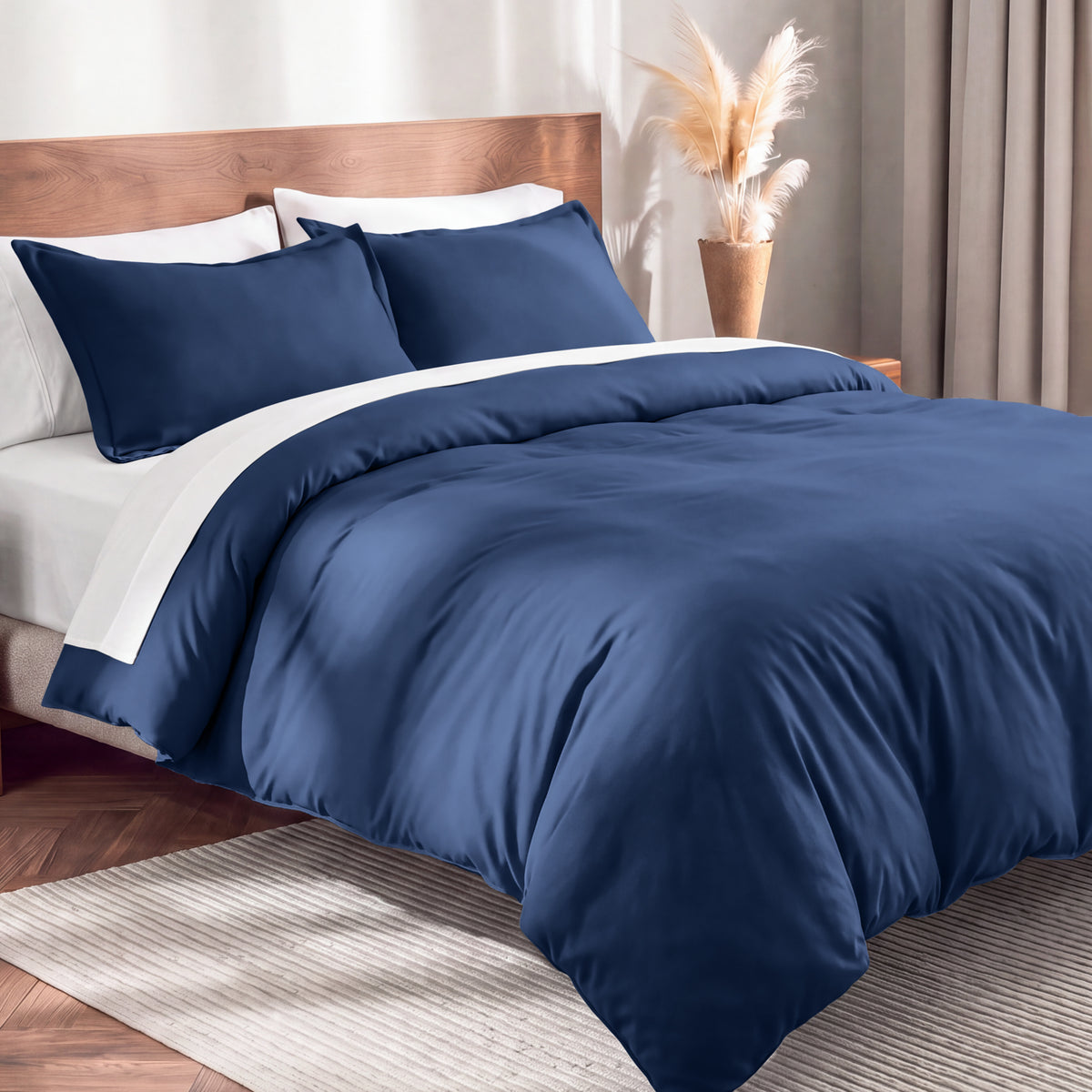 Flannel duvet cover set on a bed in a bedroom with a lamp and plant in the background.