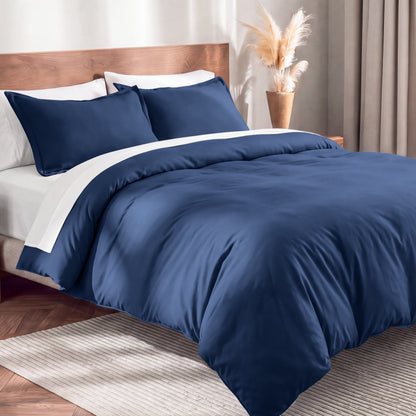 Flannel duvet cover set on a bed in a bedroom with a lamp and plant in the background.