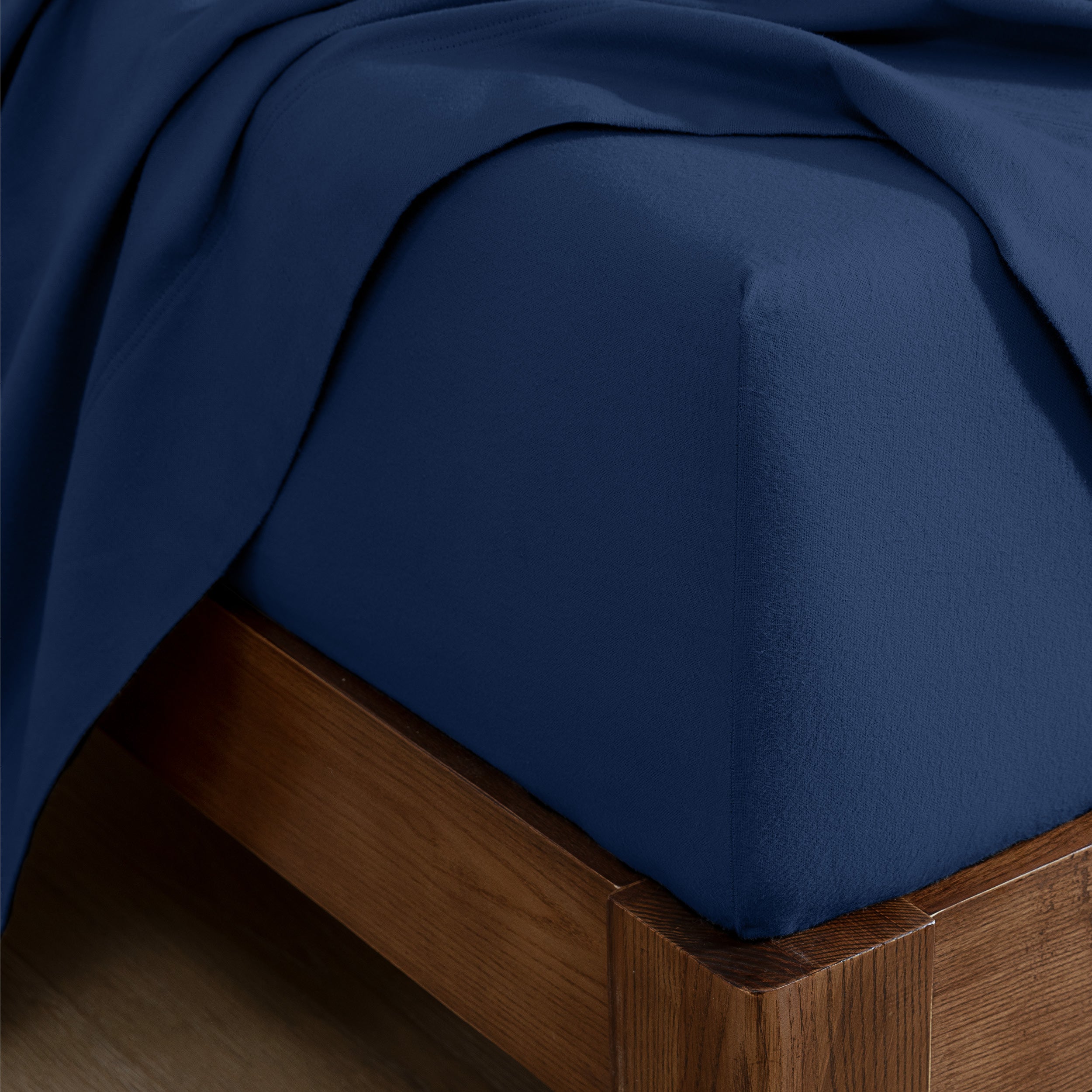 Flannel fitted sheet on a wooden bed frame