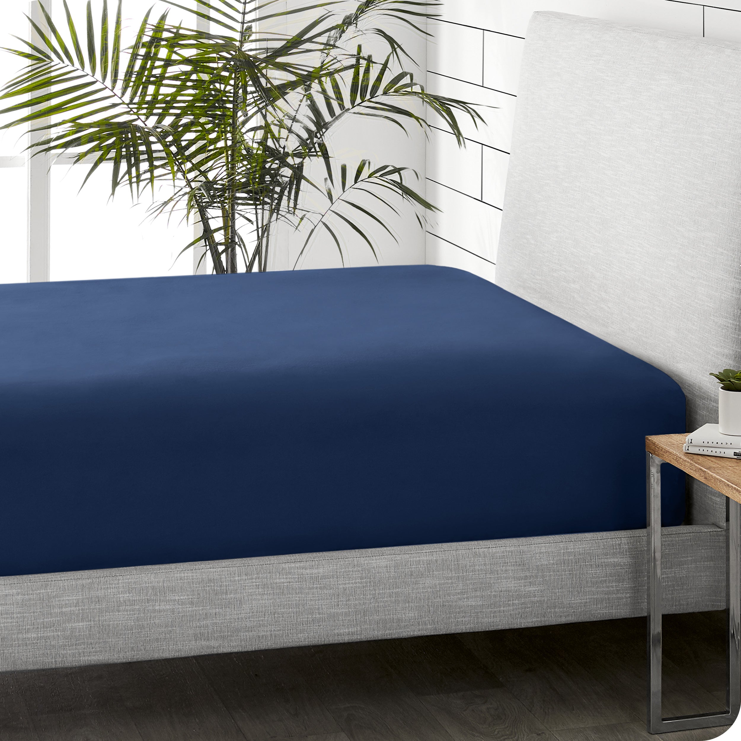 A sideview of a modern bed with a flannel fitted sheet.