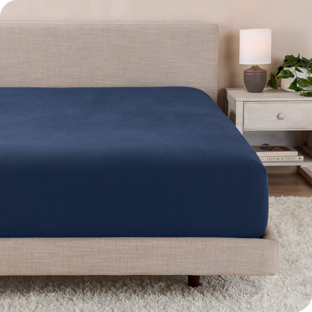 A close up of a modern bed with a flannel fitted sheet on