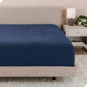 A close up of a modern bed with a flannel fitted sheet on