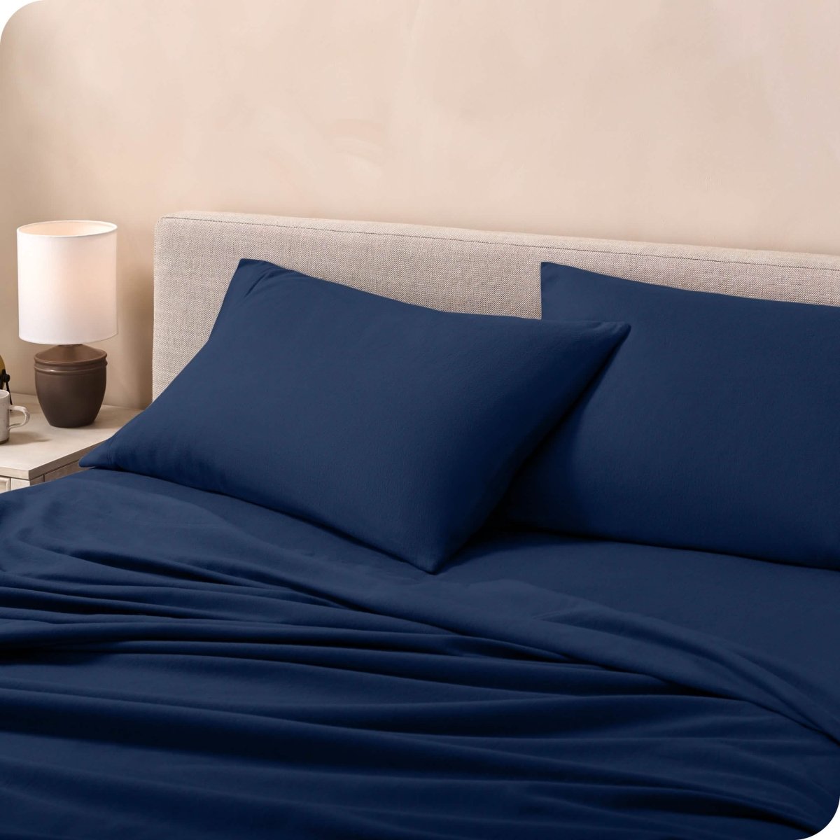 Flannel pillowcases on a mattress leaning against the headboard