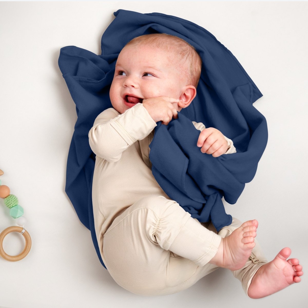 A baby lying on a flannel receiving blanket