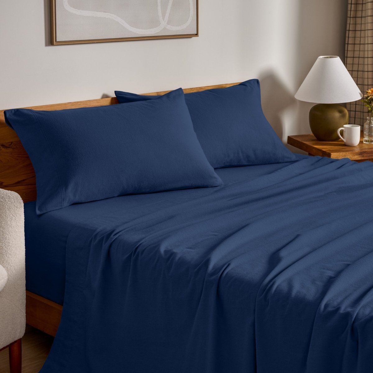 Flannel bed sheets and pillowcases on a bed in a bedroom setting.