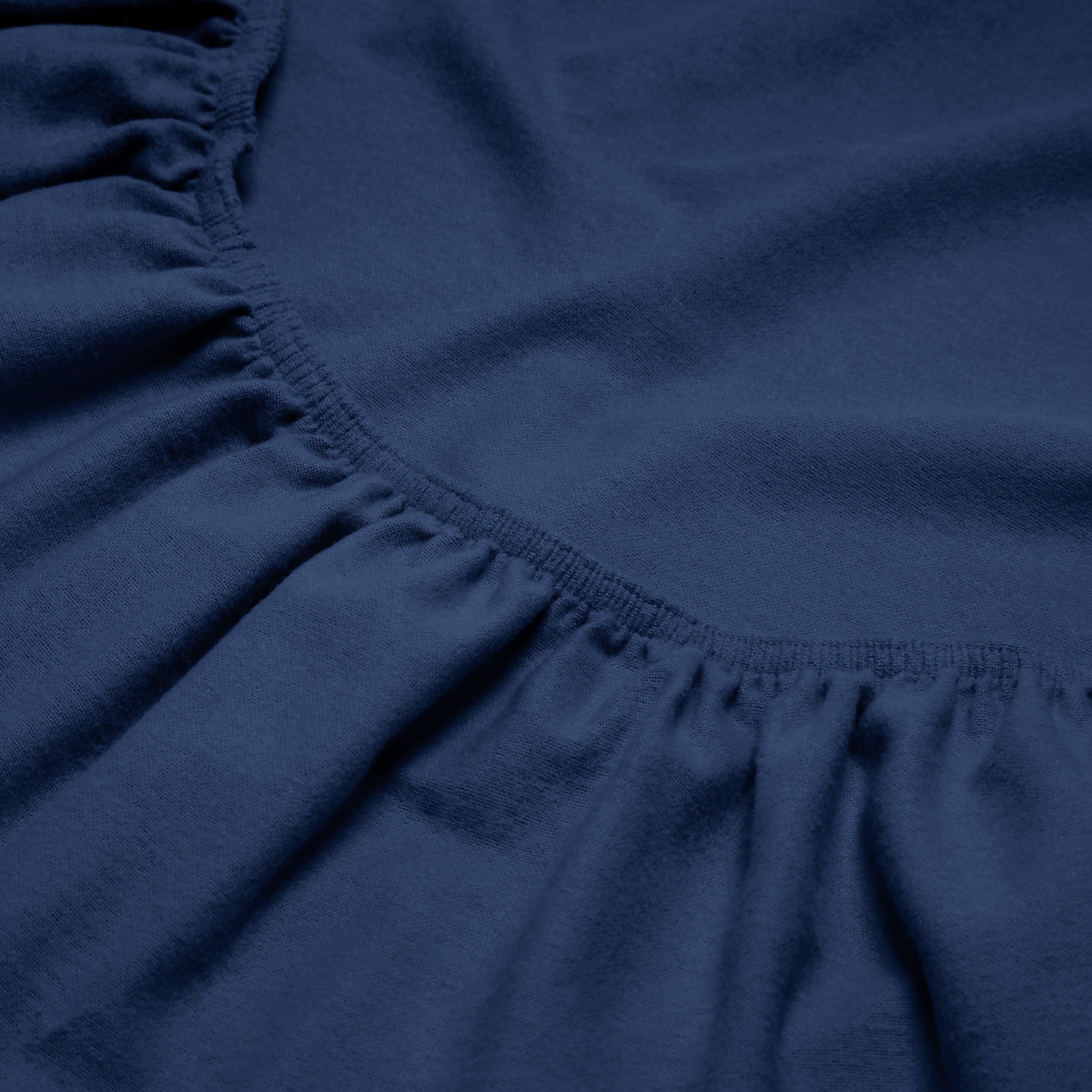 Close-up of a flannel fitted sheet with gathered elastic