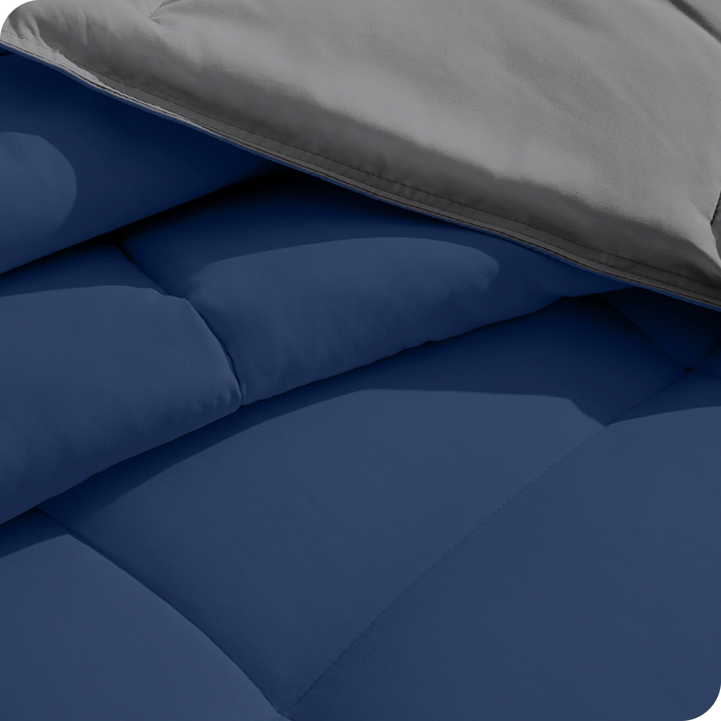 Close up of the reversible comforter showing the box stitching and the two colors