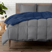 A wooden bed frame with a reversible comforter and sheet set on the mattress