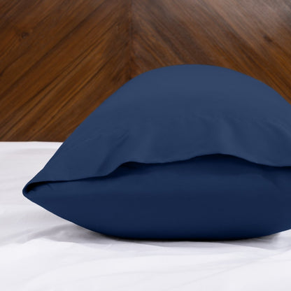 Body pillowcase with an envelope closure on a bed with a wooden headboard