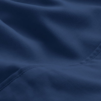A close-up of microfiber fabric with soft folds and a visible stitched seam.