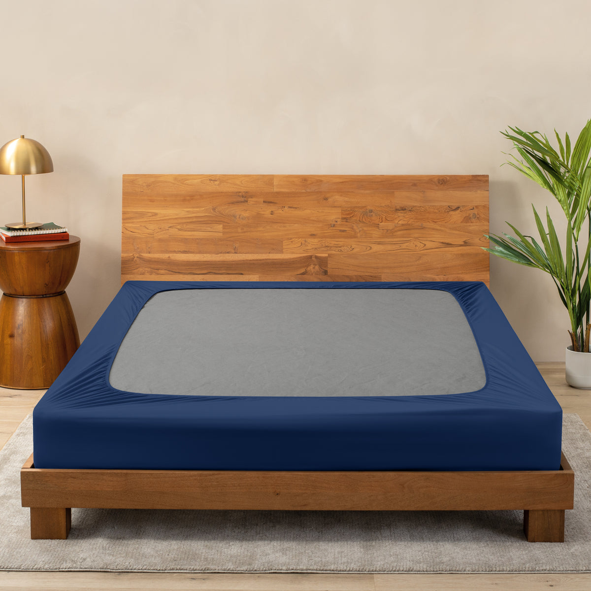 A cover on a box spring set on a wooden bed frame