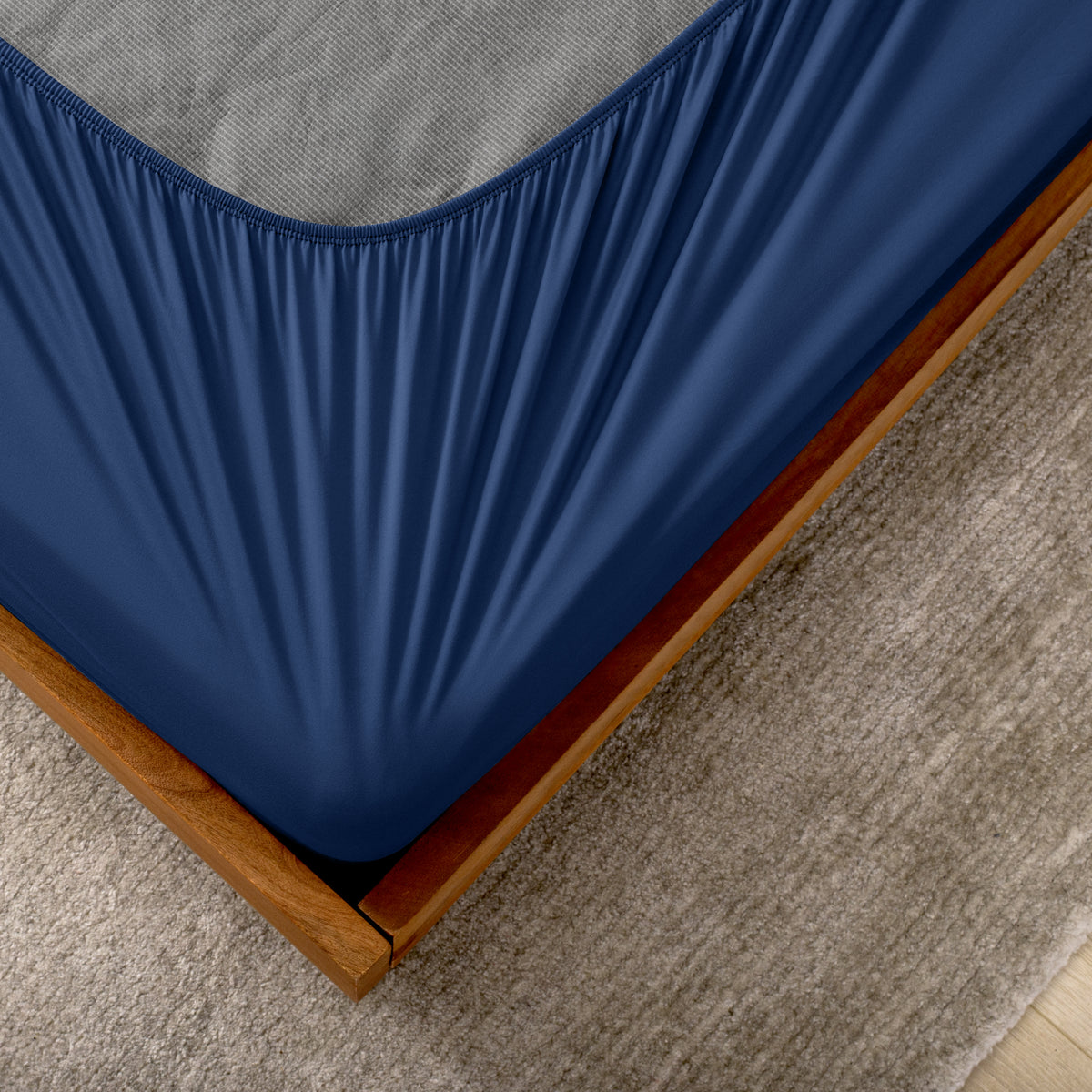 The corner of a box spring with a cover on it