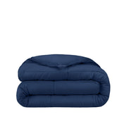Folded blue comforter on a white background