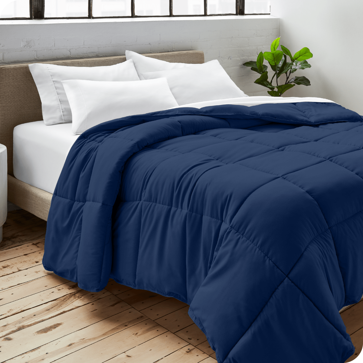A bedroom with a duvet insert, pillowcases and shams on the bed