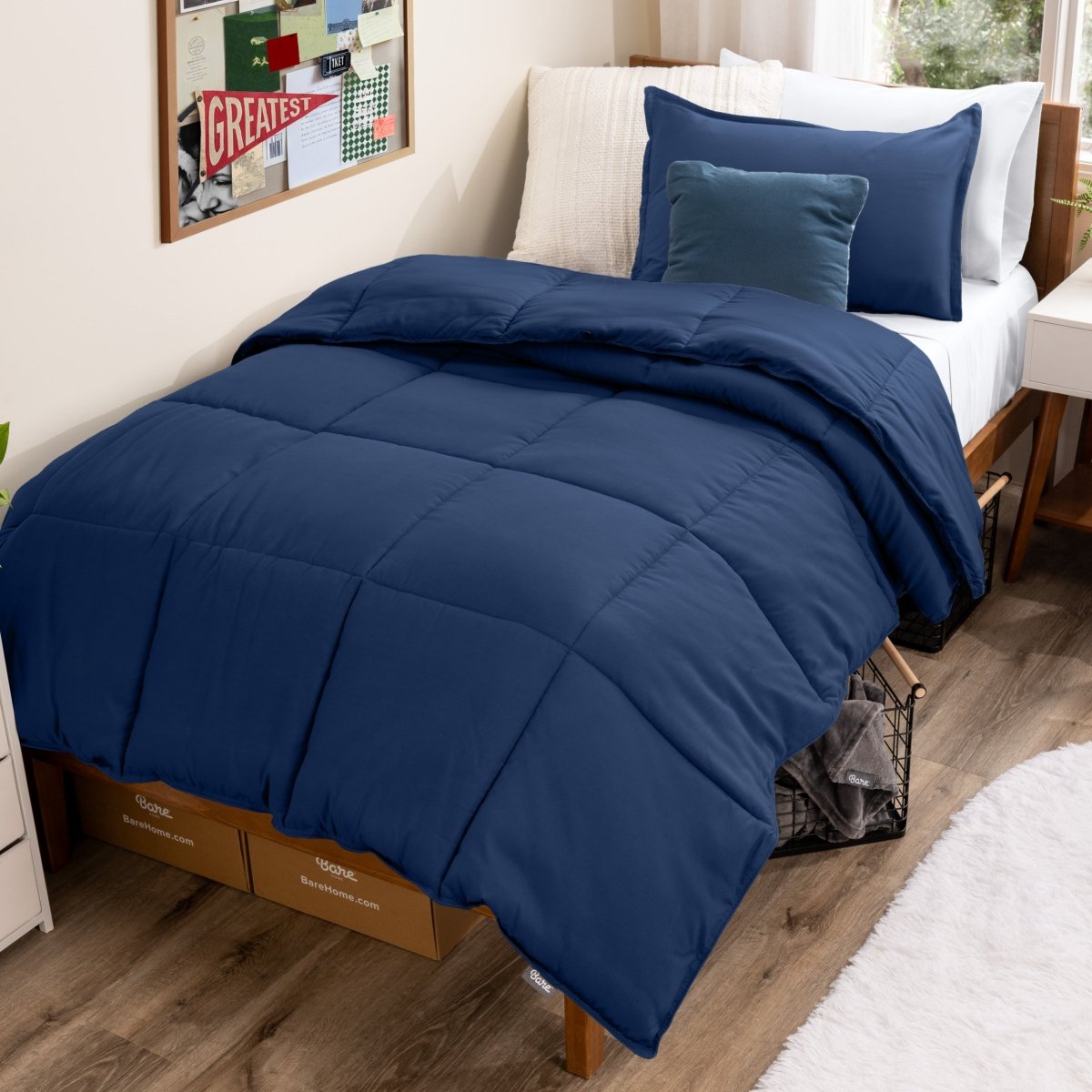 Bed with comforter and pillows in a dorm room