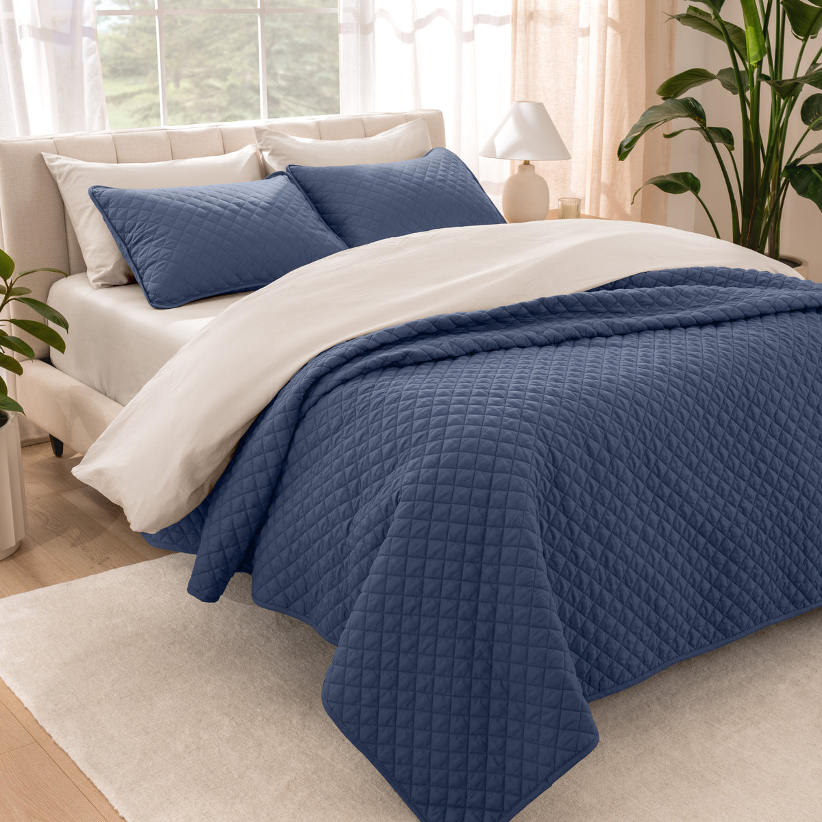 Bedroom showing coverlet set laying on the bed with the quilt folded over on itself