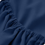 Close up of a microfiber fitted sheet showing the elastic