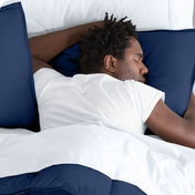 Man sleeping with his head resting on a pillow sham