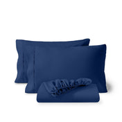 Pillowcases and a matching fitted sheet folded in front, shown on a plain white background.