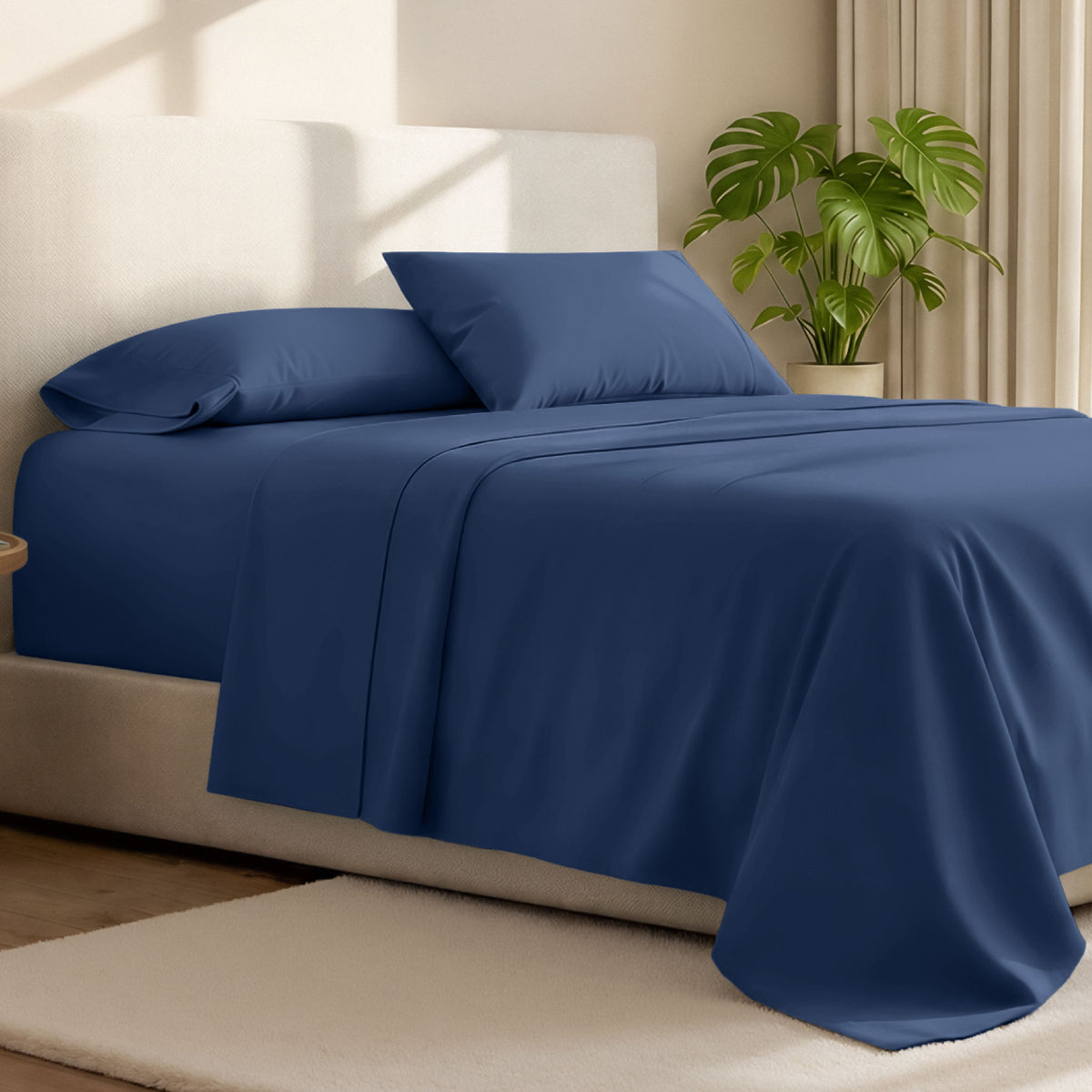 Microfiber bed sheets on a neatly made bed with a wooden headboard and nightstand.