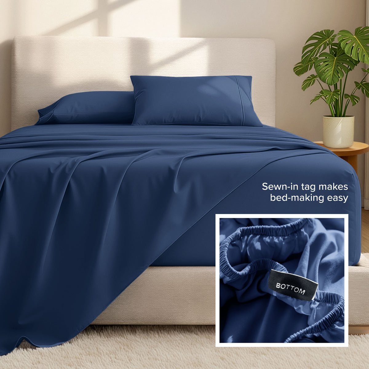 Bed sheets and pillows on a bed with a plant in the background