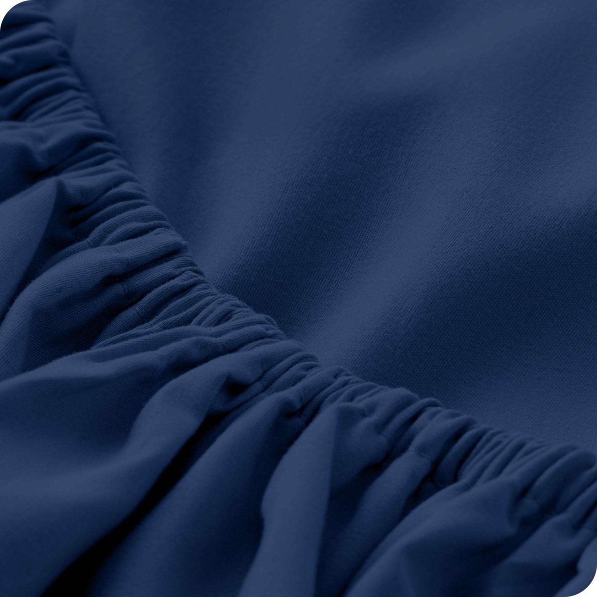 A close-up of a fitted sheet showcasing its elastic edge
