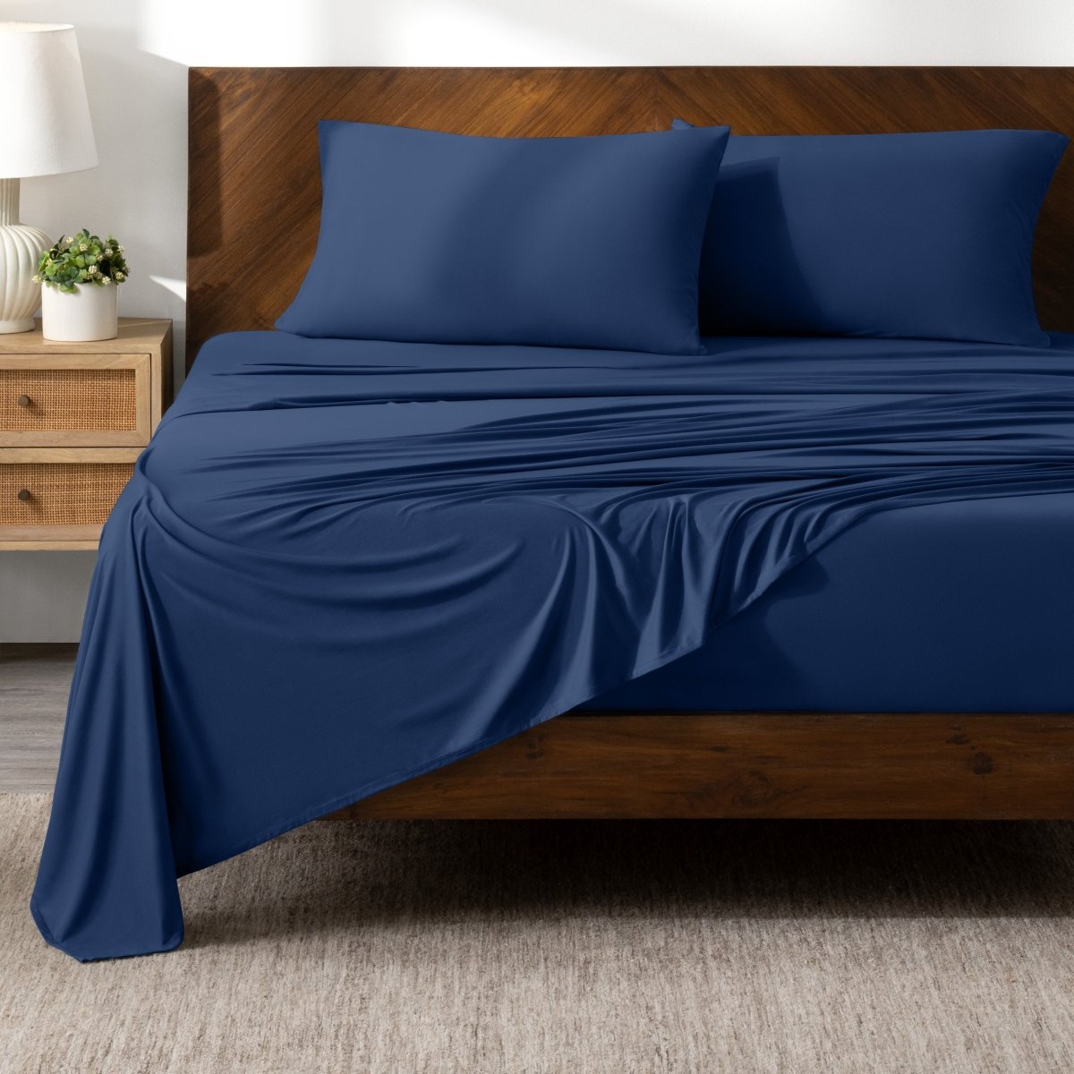 Bed sheets on a wooden bed in a bedroom setting