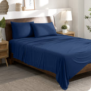 A modern bedroom set with a blue sheet set on the bed
