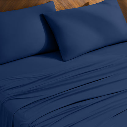 Bed sheets and pillowcases on a bed with a wooden headboard
