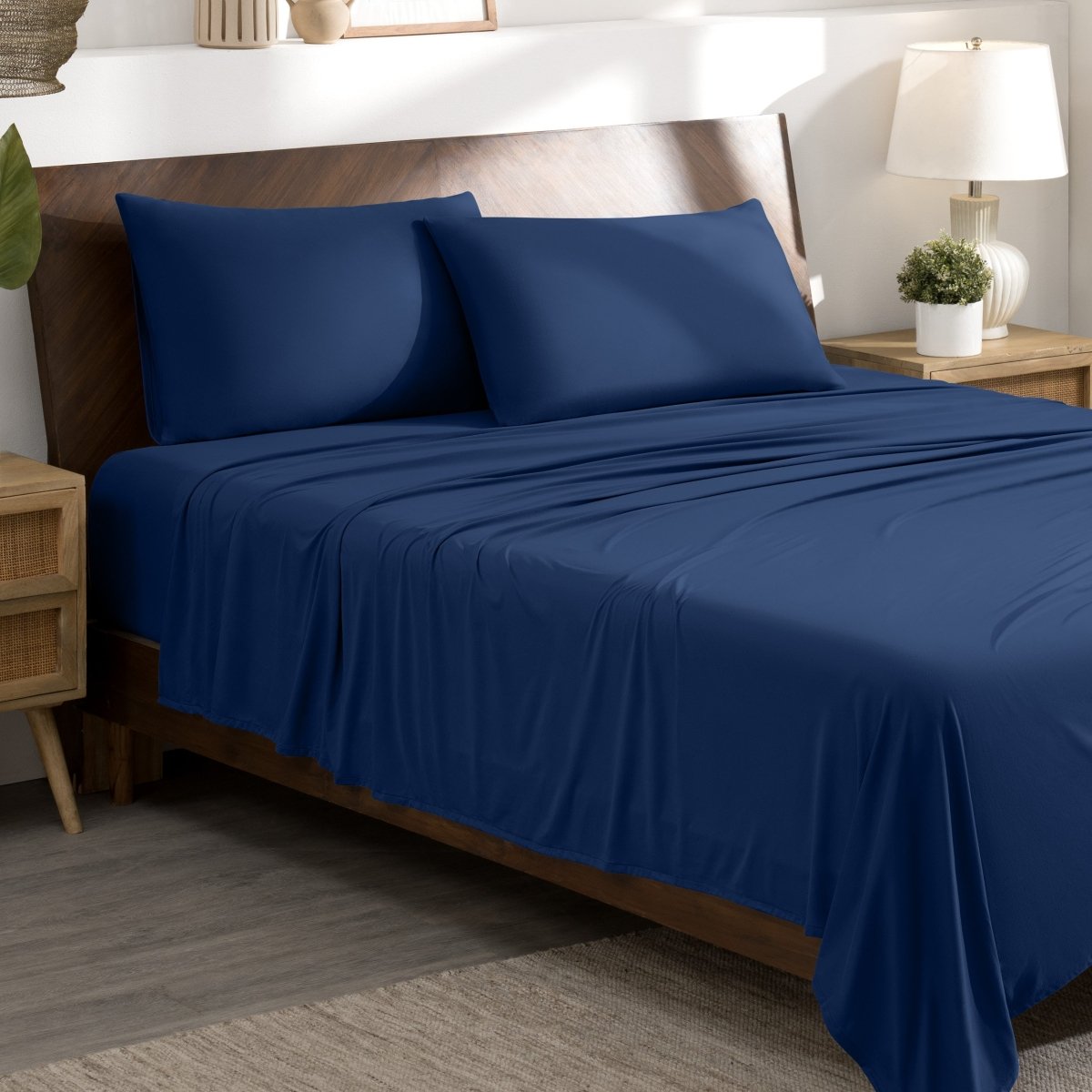 Bed sheets and pillows on a bed in a bedroom setting.