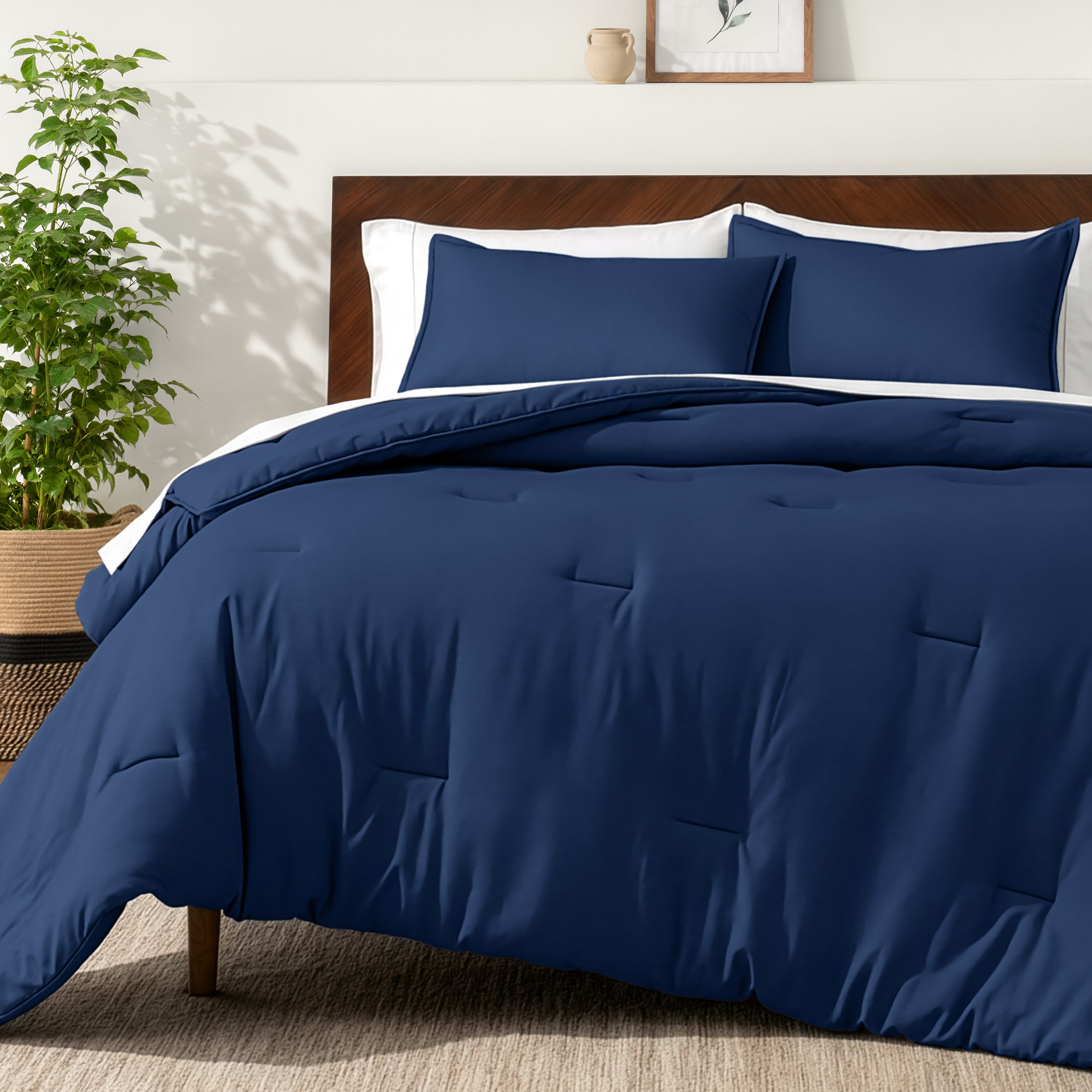 Bedding set on a bed in a bedroom with a side table and lamp.