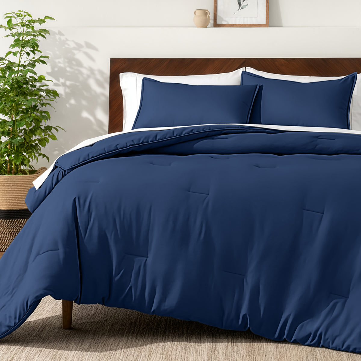 Bedding set on a bed in a bedroom with a side table and lamp.