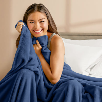 A woman cuddling with a microplush blanket